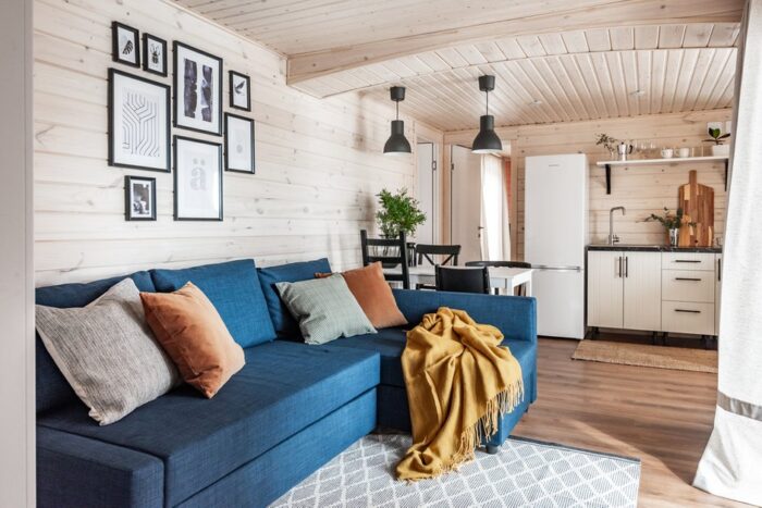 Niebieska sofa w małym pokoju dziennym to element, który przykuwa do siebie uwagę. Zdecydowany kolor współgra z prostym...