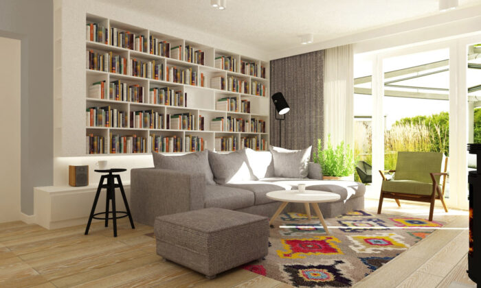 Za szarą sofą w salonie zorganizowano całkiem pojemną domową bibliotekę. Prosty zabudowany regał świetnie komponuje się...
